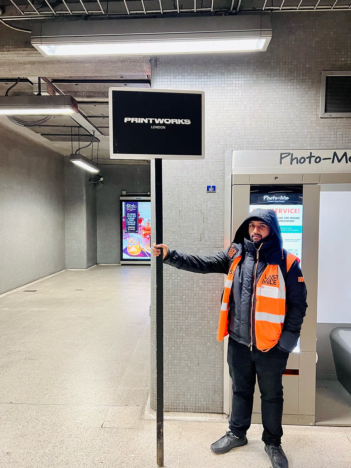 A man with a sign at the underground exit